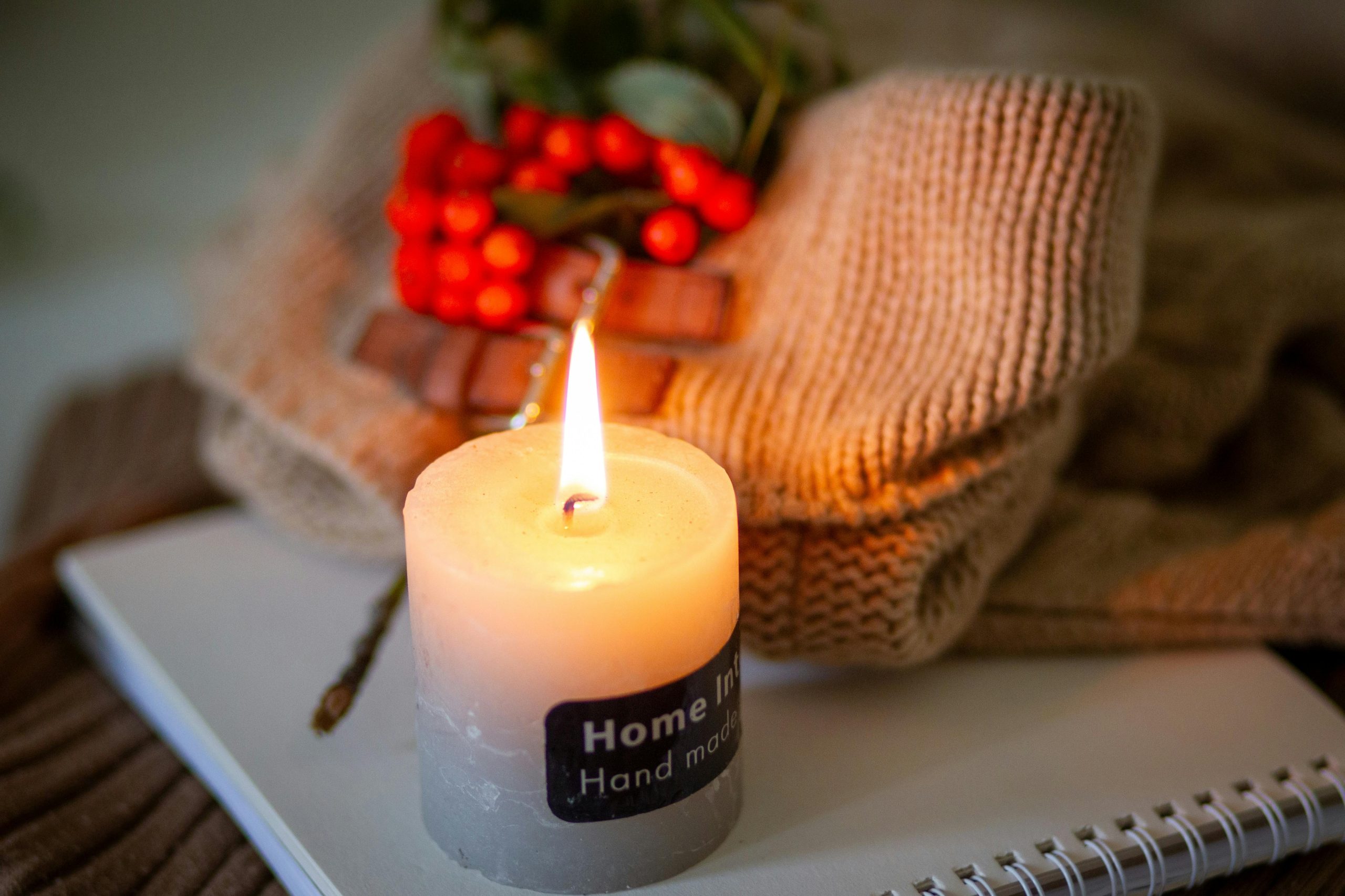 Warm candlelit scene with cozy sweater and berries, perfect for autumn ambiance.